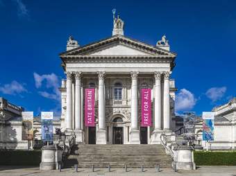 Tate Britain building against a bright blue sky